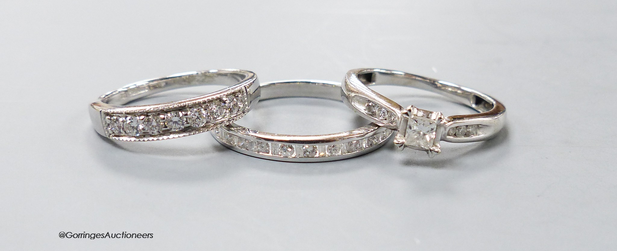 Two modern 9ct white gold and diamond set rings including a seven stone half hoop and a white metal and diamond chip set half eternity ring, gross 6.9 grams.